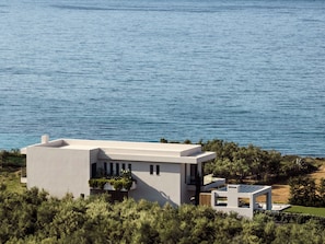 An impeccable villa reigns supremely above the Ionian Sea. 