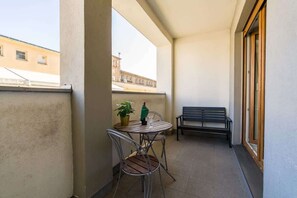 Private balcony area with a small table and chairs.
