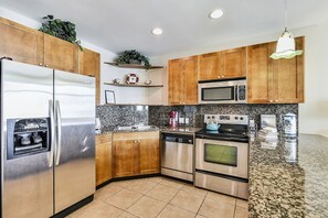 A Fully Loaded Kitchen -  With this full spread of a refrigerator, stove, and utensils, you'll have everything you need for the gourmet.