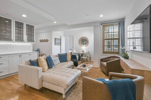 Spacious Living Room, featuring a separate Dining Area. Complete with AC, Smart TV, and comfy seating.
