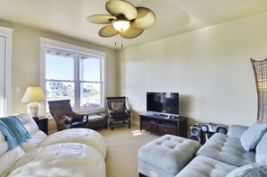 Spacious Living Room - Large comfortable couches, a flat screen TV, and ceiling fan so you can enjoy your evenings with family and lots of breathing space.