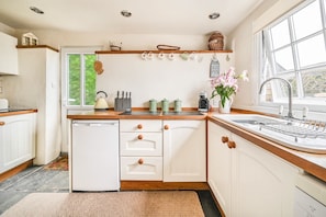 Shaker style kitchen .Slate flooring