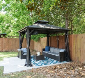 The Outdoor gazebo with TV, lights, and celling fan. 