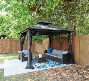 The Outdoor gazebo with TV, lights, and celling fan.
