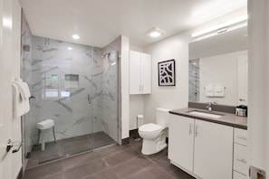 Spacious, well-lighted Bathroom with Designer-style finishes. 