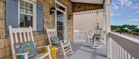 Welcome your guests and neighbors from the shaded front porch! 4 rocking chairs.