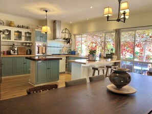 The open plan country style kitchen and large dining table for entertaining.