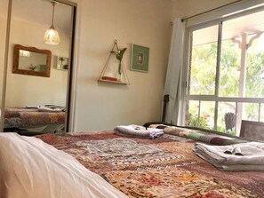 Features wall to wall windows looking onto the garden and mountains