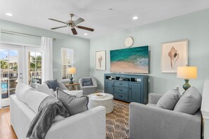 Open living area on the 2nd floor featuring a queen pullout couch, 75in TV and plenty of seating