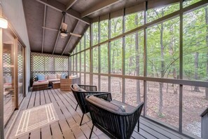 Screened porch with oversized chairs and seating area