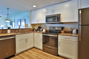 Fully Equipped Kitchen with Granite Countertops and Small Appliances