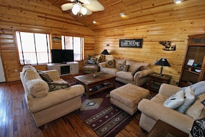 The living room has a Smart TV and fireplace and lots of comfy seating