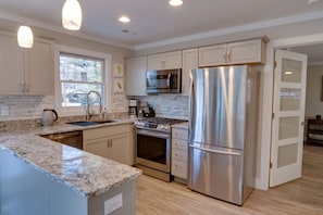 Gas range, convection oven, granite countertops, microwave, coffee maker and more. This kitchen is stocked and ready.