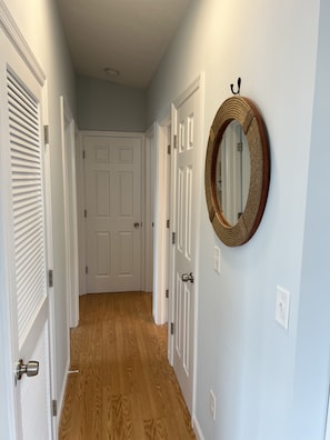 Hallway to 3 bedrooms and bathroom