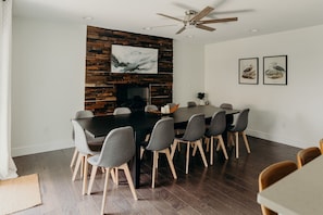 Dining room with fireplace, seats 12 at the table, plus 2 at the bar