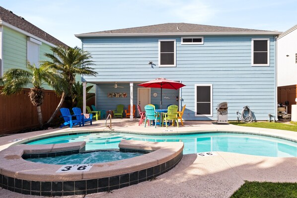 This backyard oasis offers a patio seating area and gas grill for delicious food and conversation at the patio table