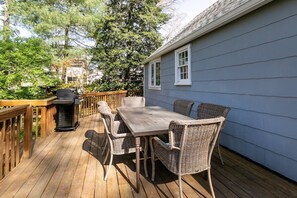 The furnished back deck is accessible from both the 1st floor bedroom and the kitchen.