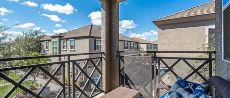 The covered balcony is the perfect place to sip your favorite beverage while visiting with friends.