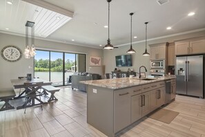 Cooks kitchen with open concept and lake view