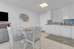 Gather round for a meal or a game of cards at the dining table for 4 in the kitchen area.