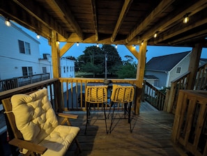 The deck has string lights that turn on automatically at night