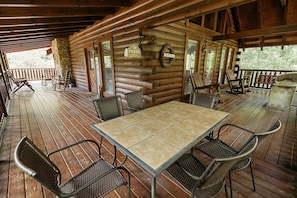Main level wrap around porch patio seating for 6. Gas grill and rockers.