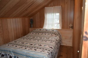 Queen size bed. Room includes a dresser and chair