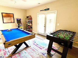 Game room with pool table, foosball, arcade Pac-Man, and tons of board games