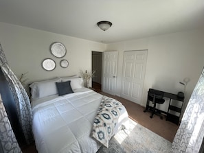 Bedroom 1 features a Queen Bed and a desk.