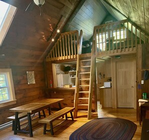 Open floor plan - view from living area of the dining table, kitchen, and loft.