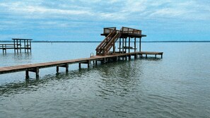 Boat dock features a v-hull boat lift, two small Jet ski lifts, and a sundeck! 