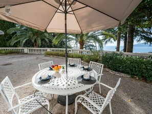 Table, Plant, Furniture, Property, Umbrella, Building, Chair, Outdoor Table, Outdoor Furniture, Shade