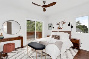 Our third bedroom, which is complete with a Queen bed, closet, vanity, vanity chair, and nearby bath.