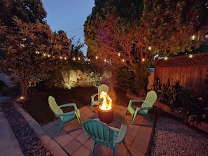 Sit around the firepit under the trees and chat or have glass of wine