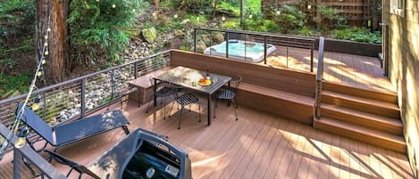 Enjoy the hot tub on this expansive deck surrounded by redwoods