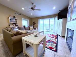 Living area with river views, sliding door to deck