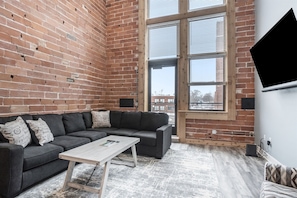 Living room area with TV and private balcony