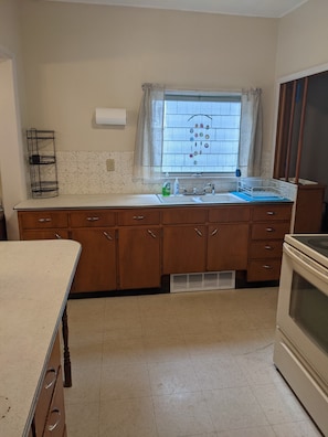 Kitchen has lots of storage stocked with equipment for cooking and baking.