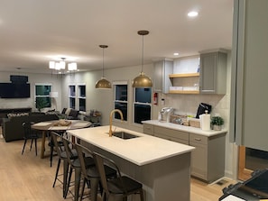 Fully stocked kitchen with dishes, cooking & eating utensils, & full size fridge
