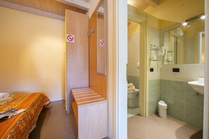 Sleeping area with double bed, two bedside tables, wardrobe with safe