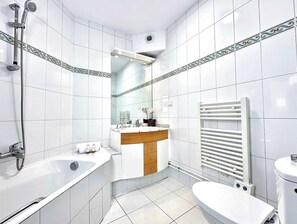 A full equipped bathroom with bath and toilets