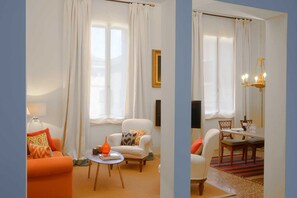 View of the living room from the entry with two large windows for good natural light.