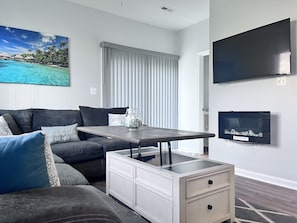 Family room with smart TV and wall mounted electric fireplace, foosball & games