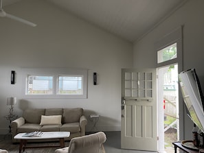 View of the living room and front door from the kitchen.