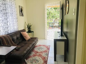 Sitting room with futon and smart tv with Netflix access.