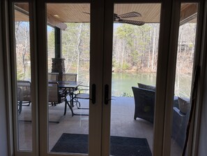 View of patio and lake from living room.