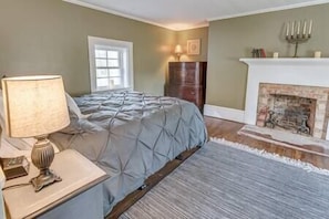 Bedroom is upstairs and features the original fireplace and a reading nook.