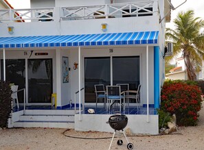 Outdoor lower balcony with awning and extended porch. 