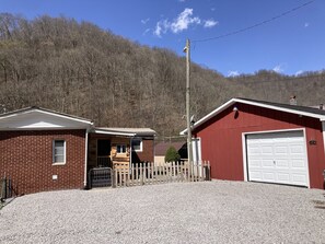 Parking by garage and entrance through enclosed porch.