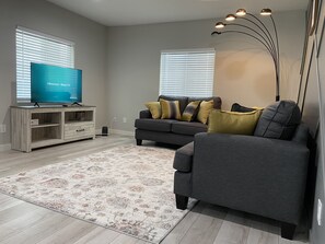 Living room with TV Console, 50" LED Roku Smart TV and couch